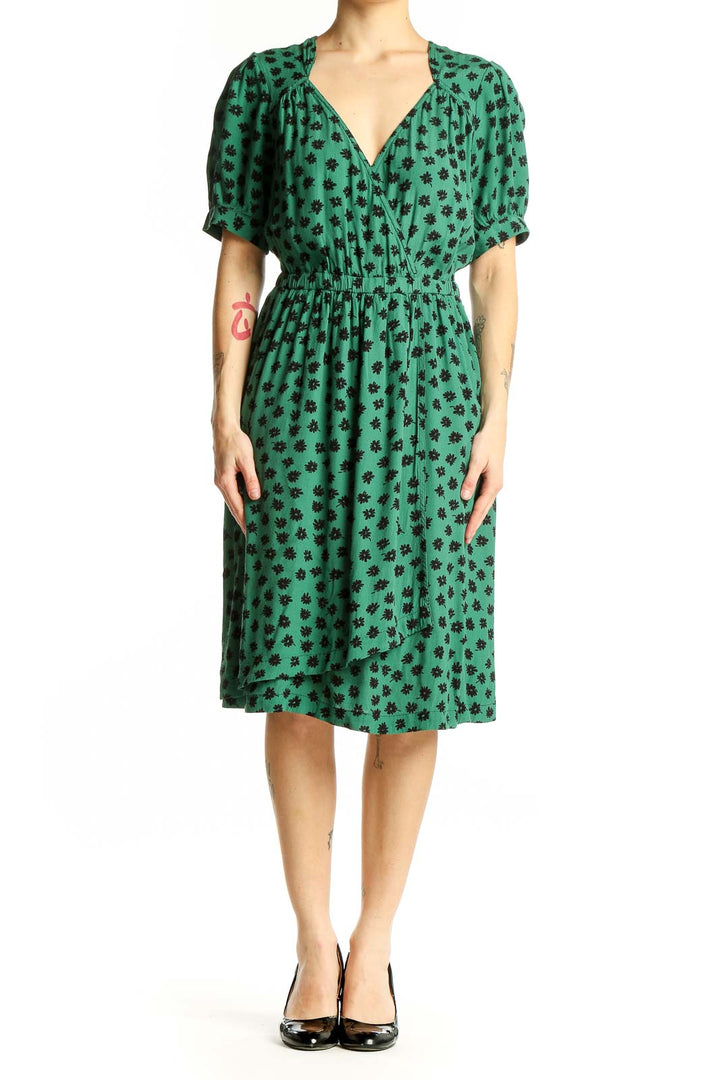 Front view of Maeve green floral print wrap dress with puff sleeves