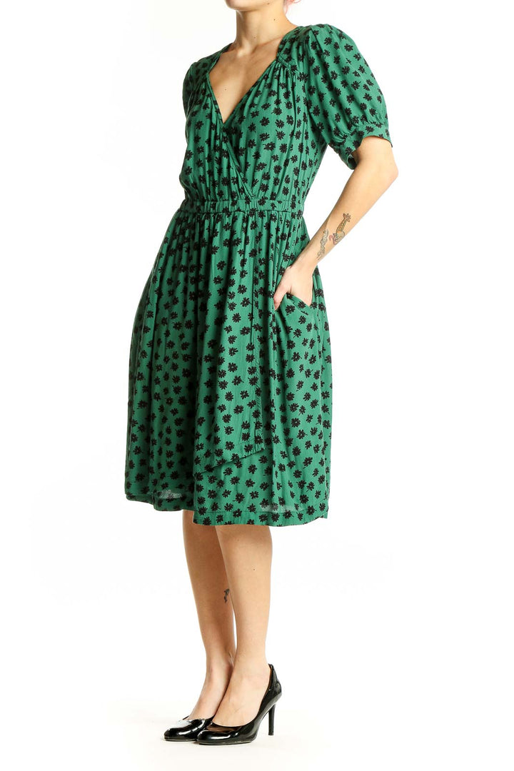 Front view of Maeve green floral print wrap dress with puff sleeves