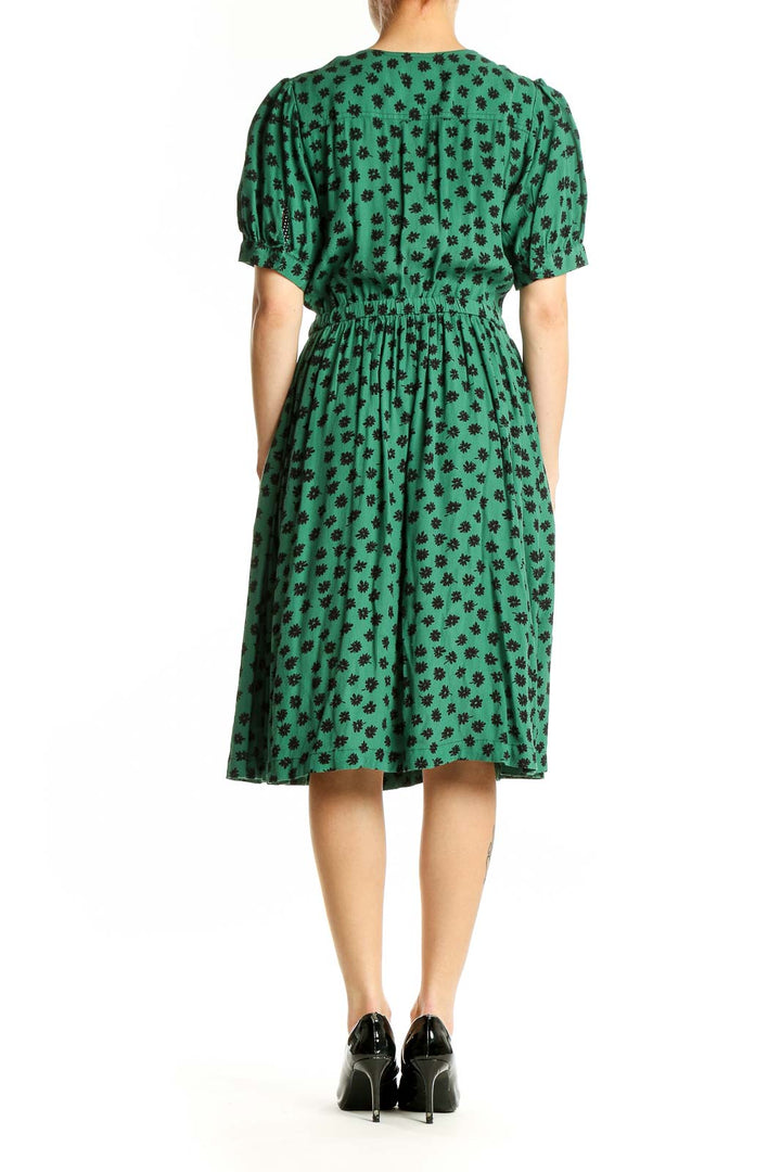 Side view of Maeve green floral print wrap dress showing wrap detail and flowy skirt