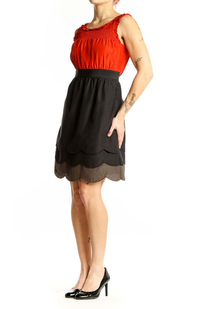 Front view of Maeve red silk dress with ruched bodice and scalloped skirt