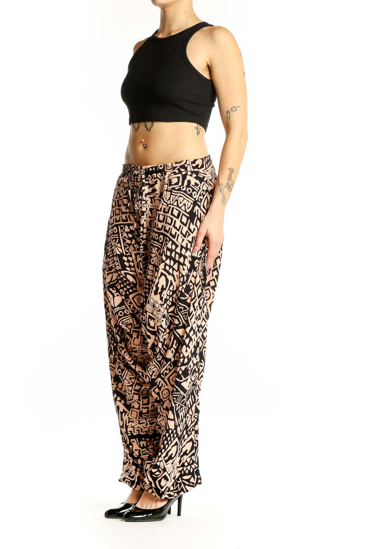 Front view of black and tan geometric print wide-leg pants by Buddha Pants