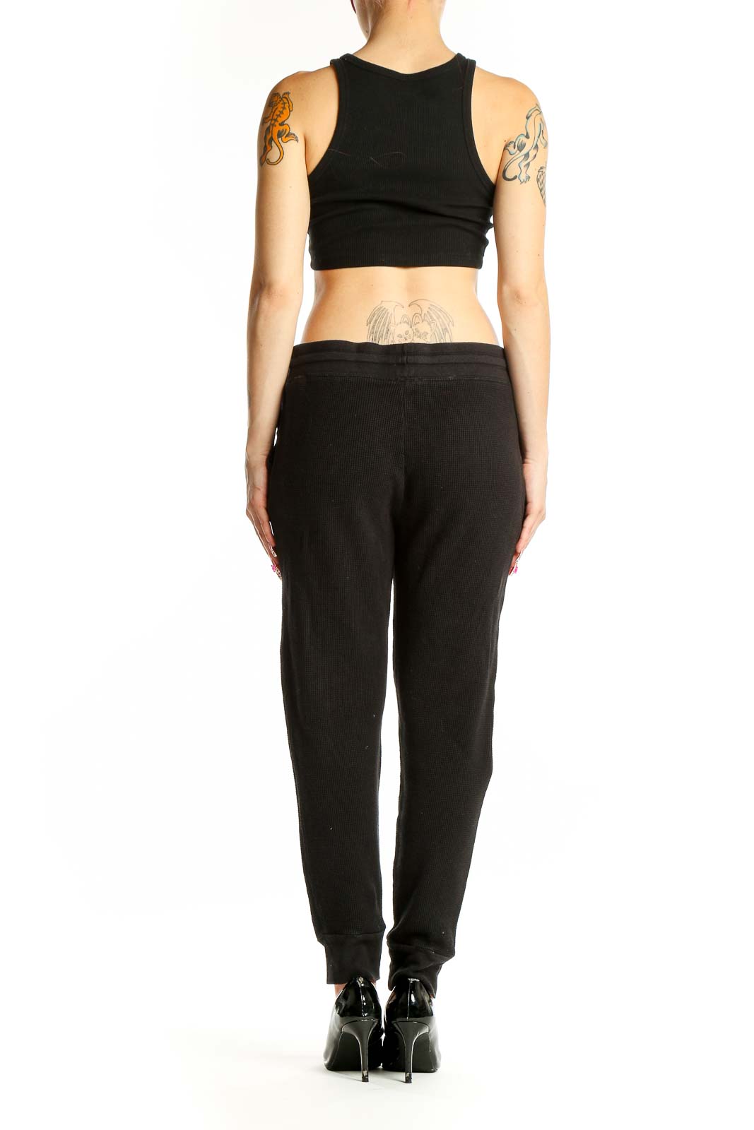 Side view of woman wearing black Splendid joggers and crop top