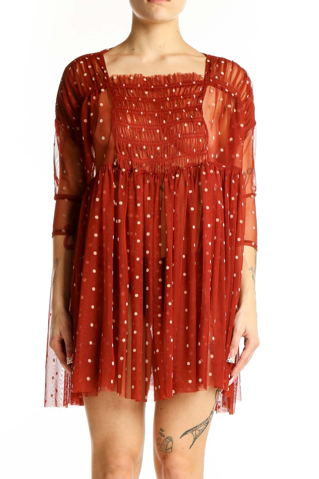Front view of Free People rust polka dot sheer babydoll dress with smocked bodice