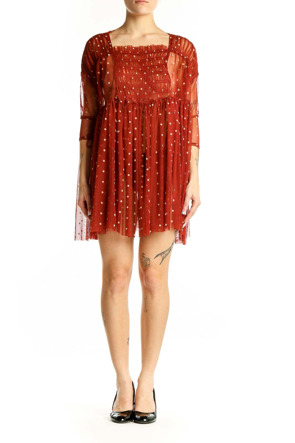 Front view of Free People rust polka dot sheer babydoll dress with smocked bodice
