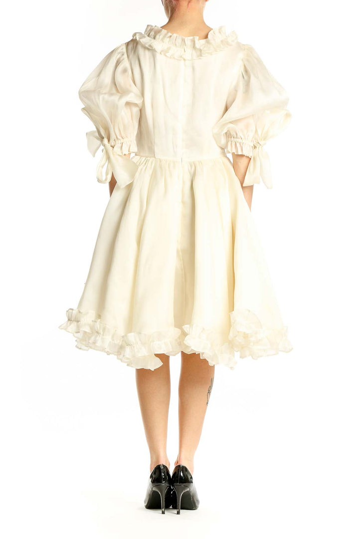 Side view of Selkie Collection ivory silk wrap dress showing flowy skirt and waist tie