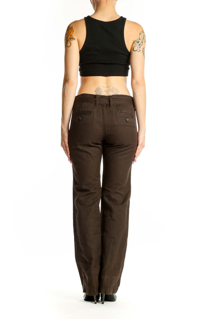 Side view of woman wearing brown Banana Republic pants with black top