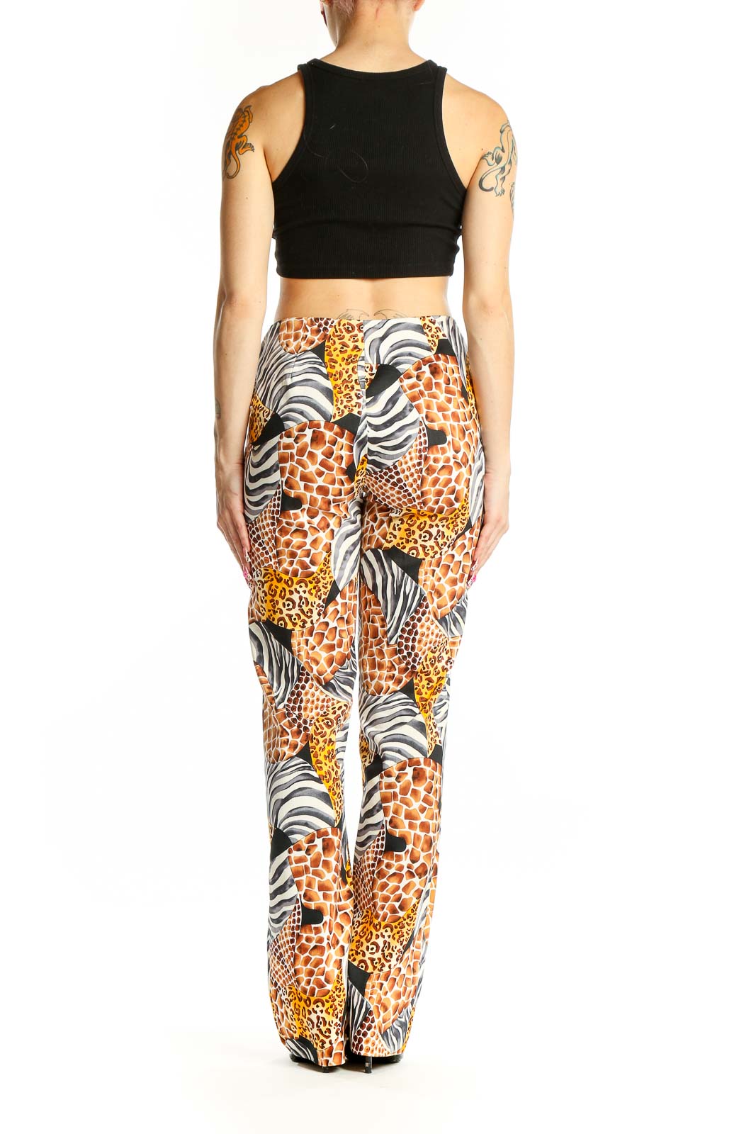 Side view of model wearing Cache animal print wide-leg pants with black crop top