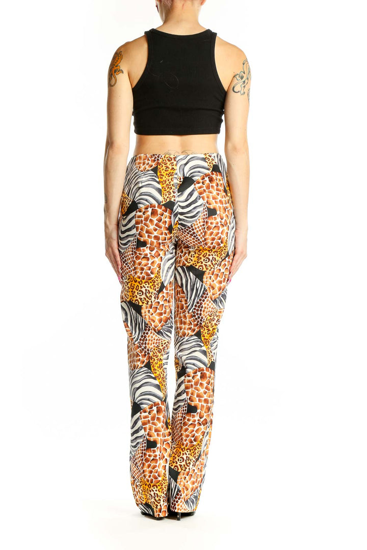 Side view of model wearing Cache animal print wide-leg pants with black crop top