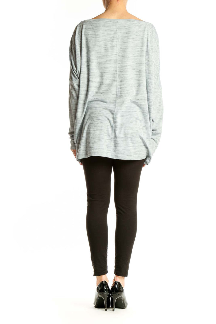 Back view of light gray oversized Athleta activewear top on model