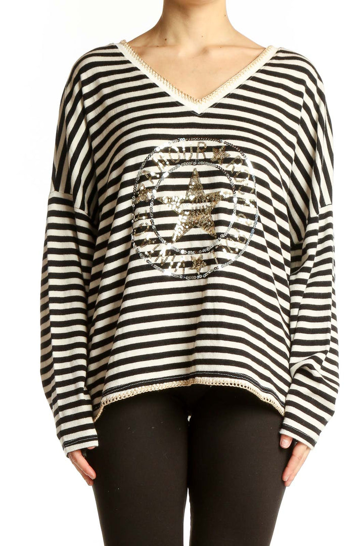 Front view of Venti6 black and white striped V-neck top with gold star design