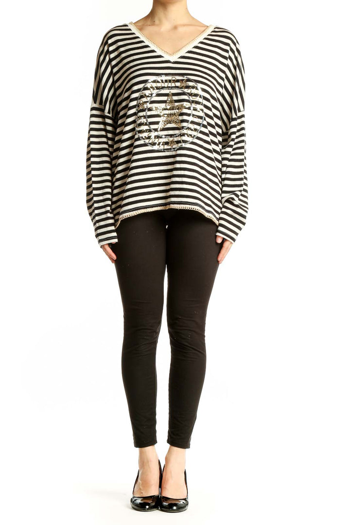 Front view of Venti6 black and white striped V-neck top with gold star design