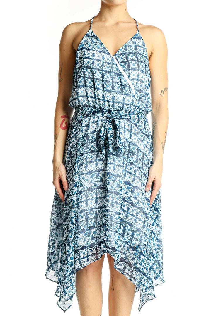 Front view of blue geometric print halter dress with wrap-style bodice