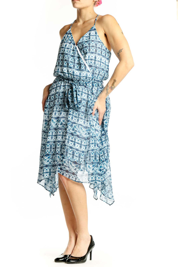 Front view of blue geometric print halter dress with wrap-style bodice