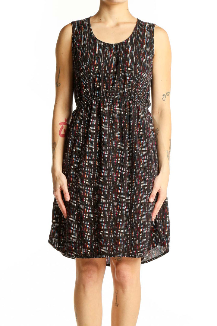 Front view of Kavu black sleeveless dress with colorful dot pattern