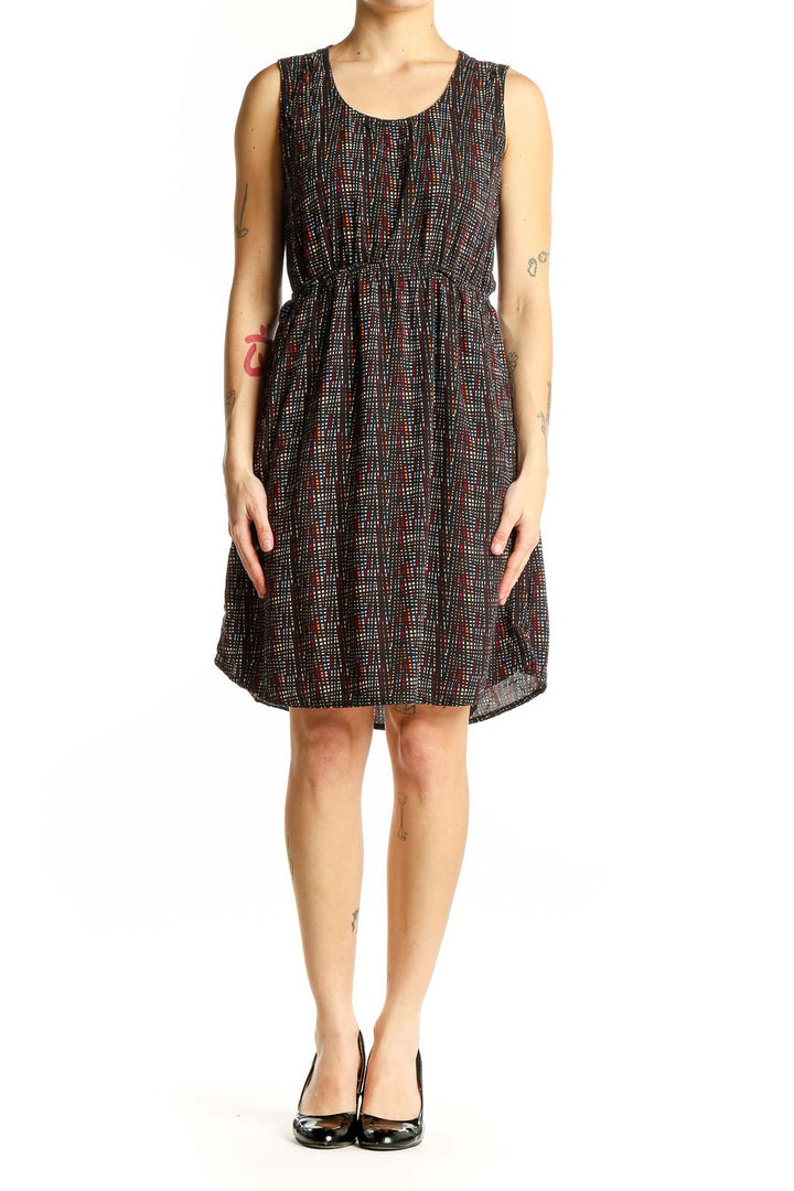 Front view of Kavu black sleeveless dress with colorful dot pattern