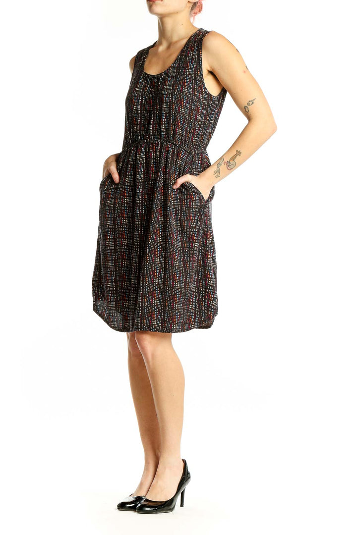 Front view of Kavu black sleeveless dress with colorful dot pattern