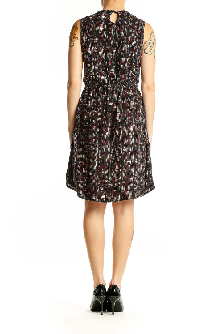 Side view of Kavu black sleeveless dress showing gathered waist and pockets