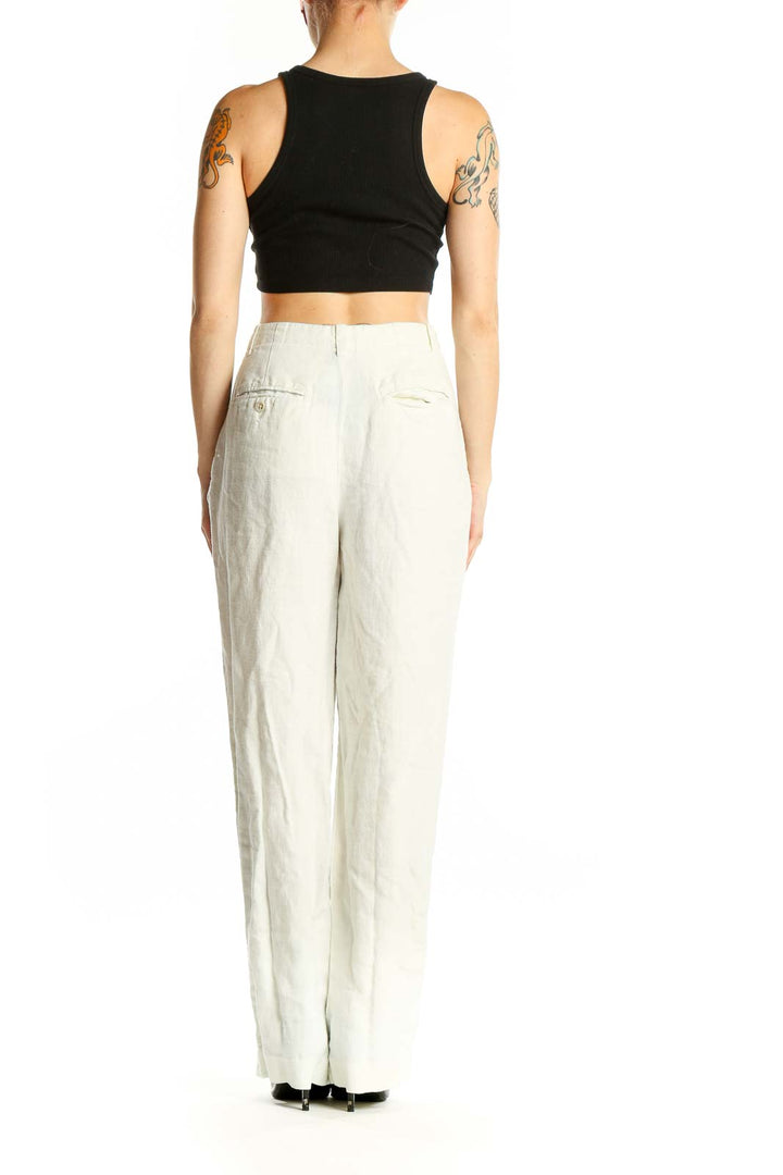 Side view of Banana Republic white linen wide-leg trousers on model with black top