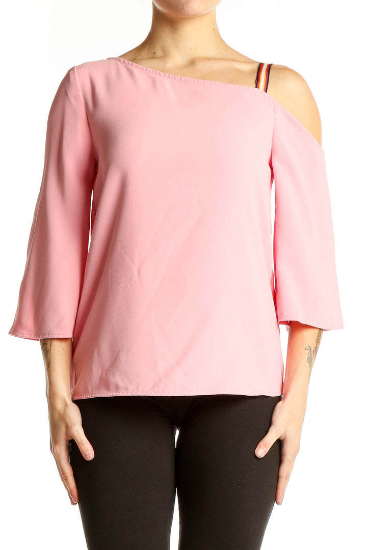 Front view of pink off-shoulder blouse by Trina Turk with asymmetrical neckline