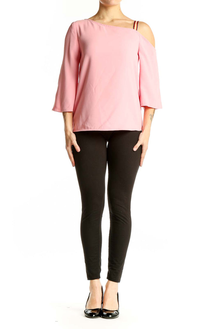 Front view of pink off-shoulder blouse by Trina Turk with asymmetrical neckline