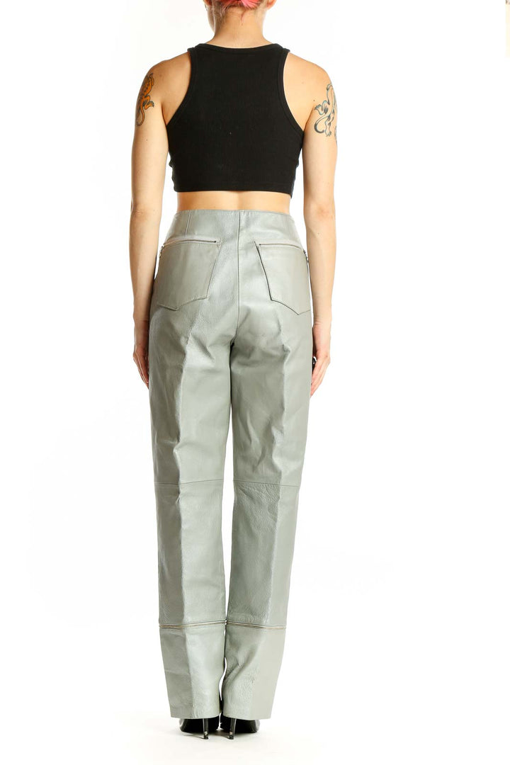 Side view of model wearing sage green high-waisted polyester pants from metrostyle