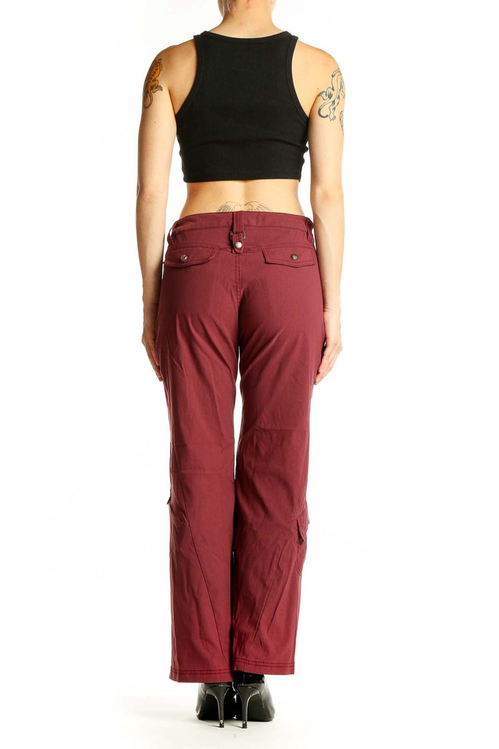 Side view of woman wearing burgundy Athleta wide-leg pants with black top