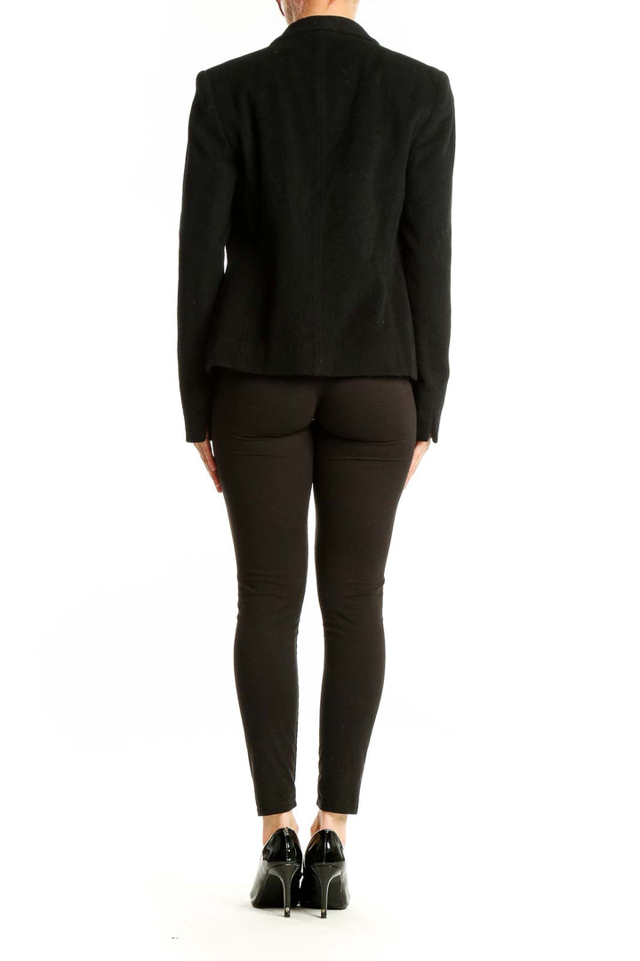 Back view of black Louben open-front blazer on model with full outfit