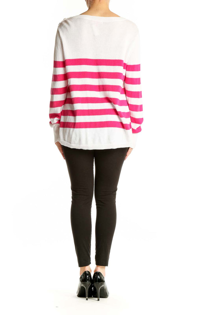 Side view of model wearing Lilly Pulitzer pink and white striped cotton knit sweater with black pants