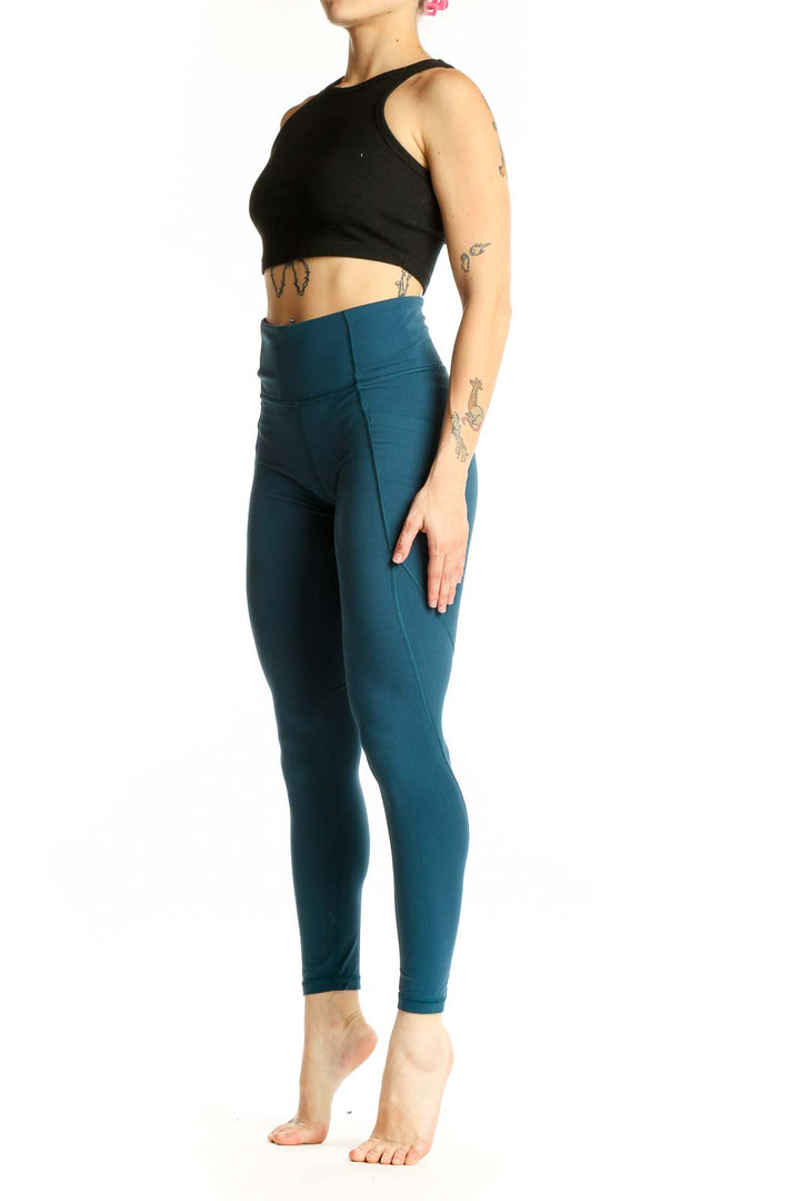 Front view of teal Athleta high-waisted performance leggings