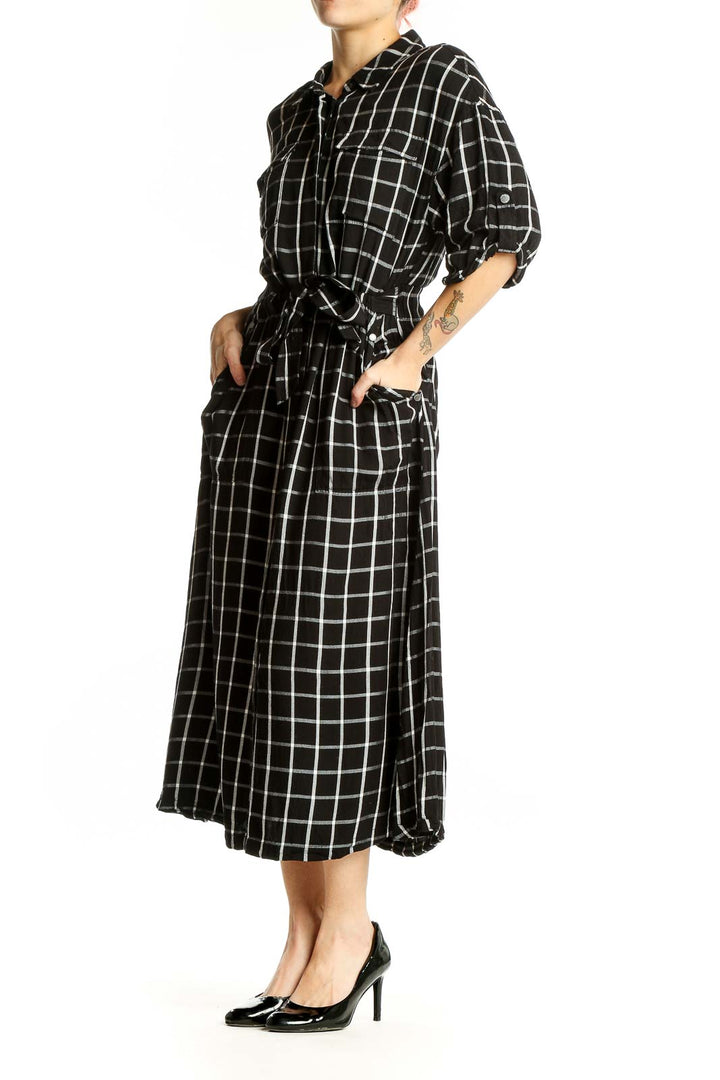 Front view of Calvin Klein black and white plaid midi shirt dress with belt