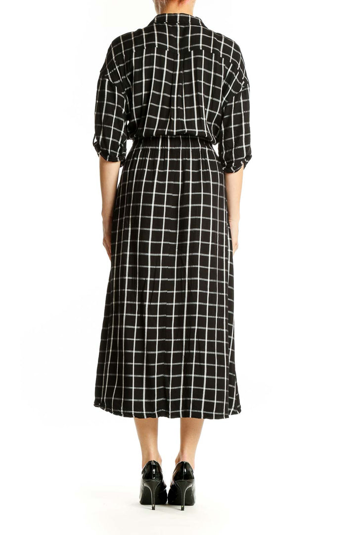 Side view of Calvin Klein black and white plaid midi shirt dress showing silhouette