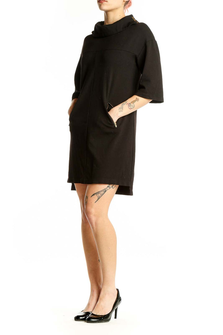 Front view of Komarov black cowl neck shift dress with 3/4 sleeves