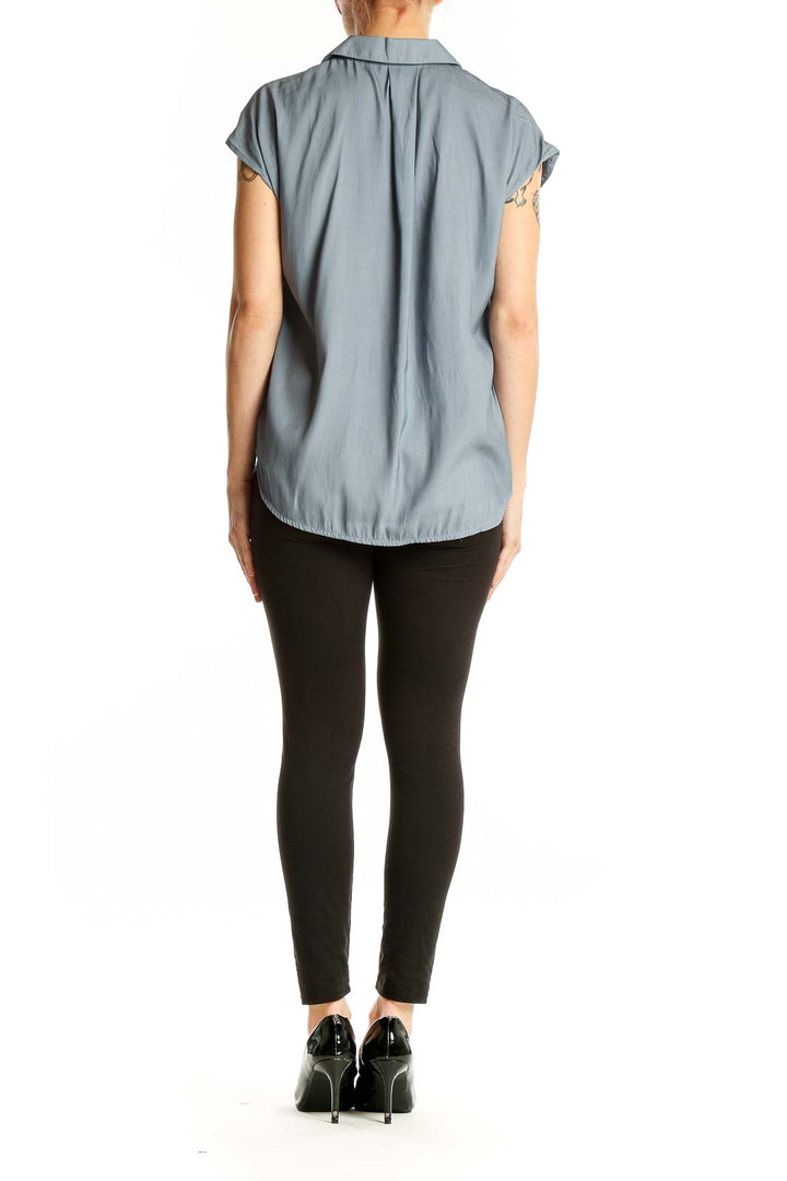 Side view of T Tahari blue polyester short-sleeve button-up blouse on model