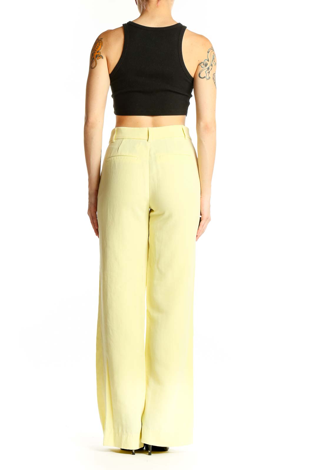 Side view of Zara yellow wide-leg trousers on model with black crop top