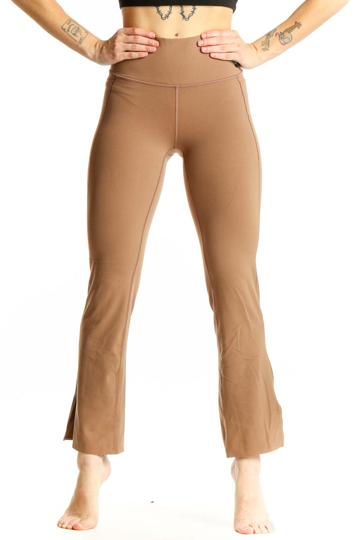 Front view of tan high-waisted flare yoga pants from Athleta