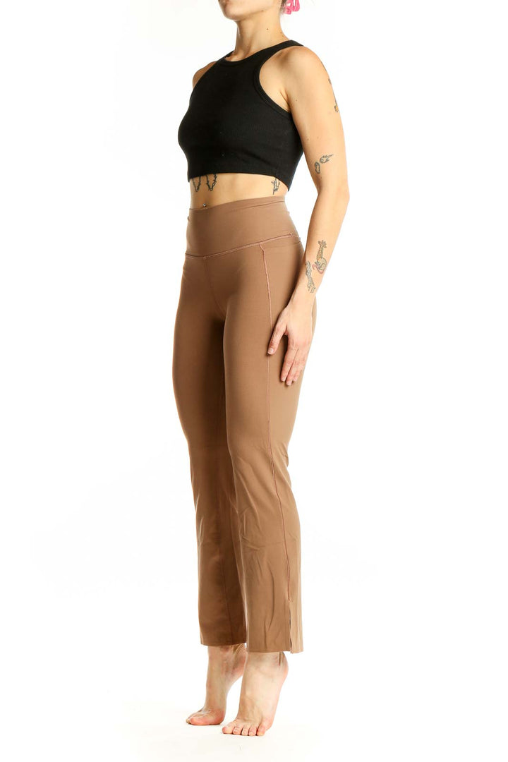 Front view of tan high-waisted flare yoga pants from Athleta