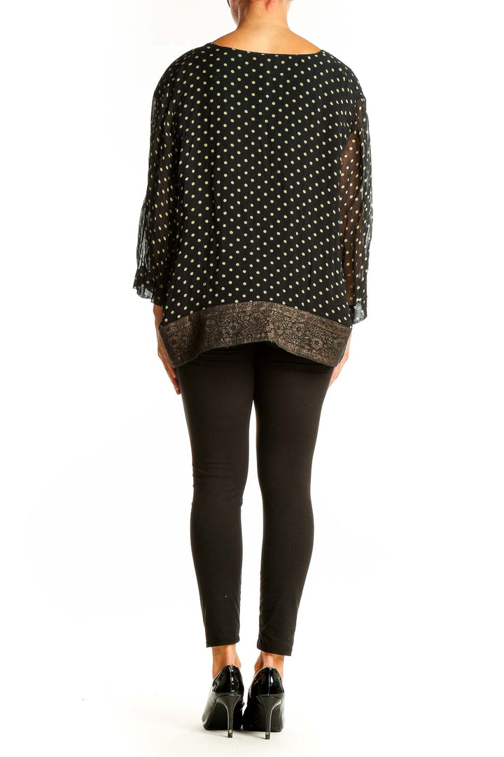 Back view of April Cornell black polka dot blouse showing relaxed fit and long sleeves