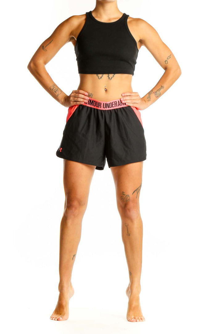 Front view of black Under Armour athletic shorts with pink side panels and elastic waistband