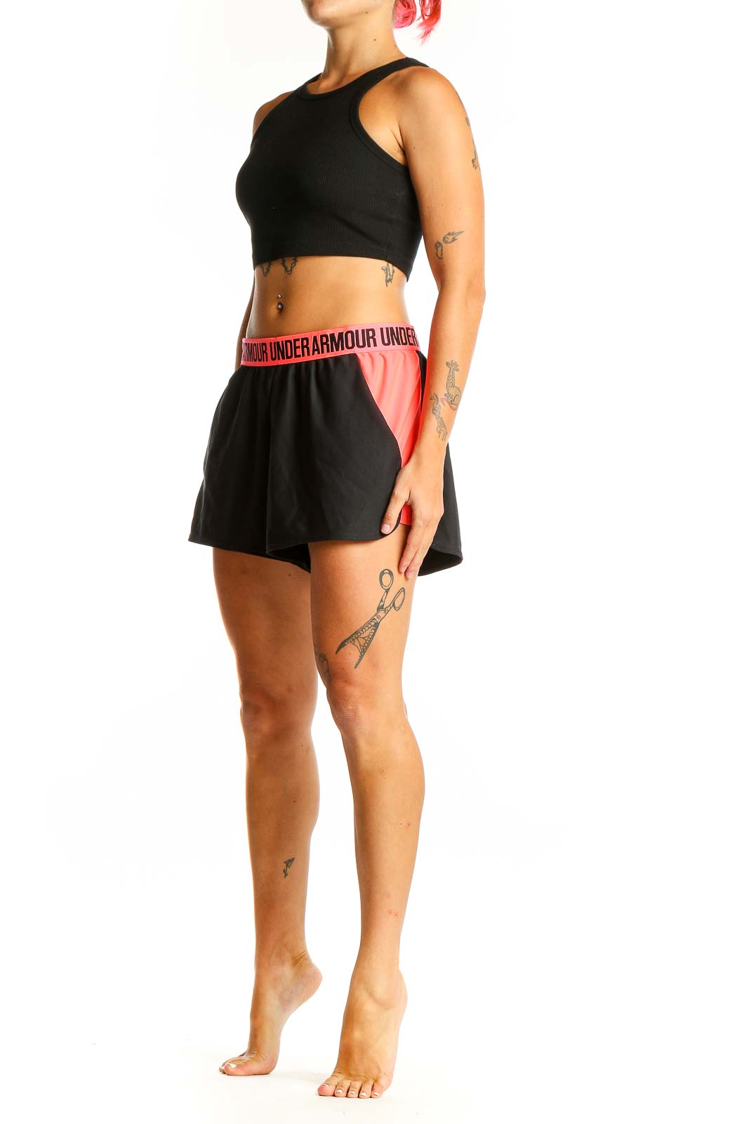 Front view of black Under Armour athletic shorts with pink side panels and elastic waistband