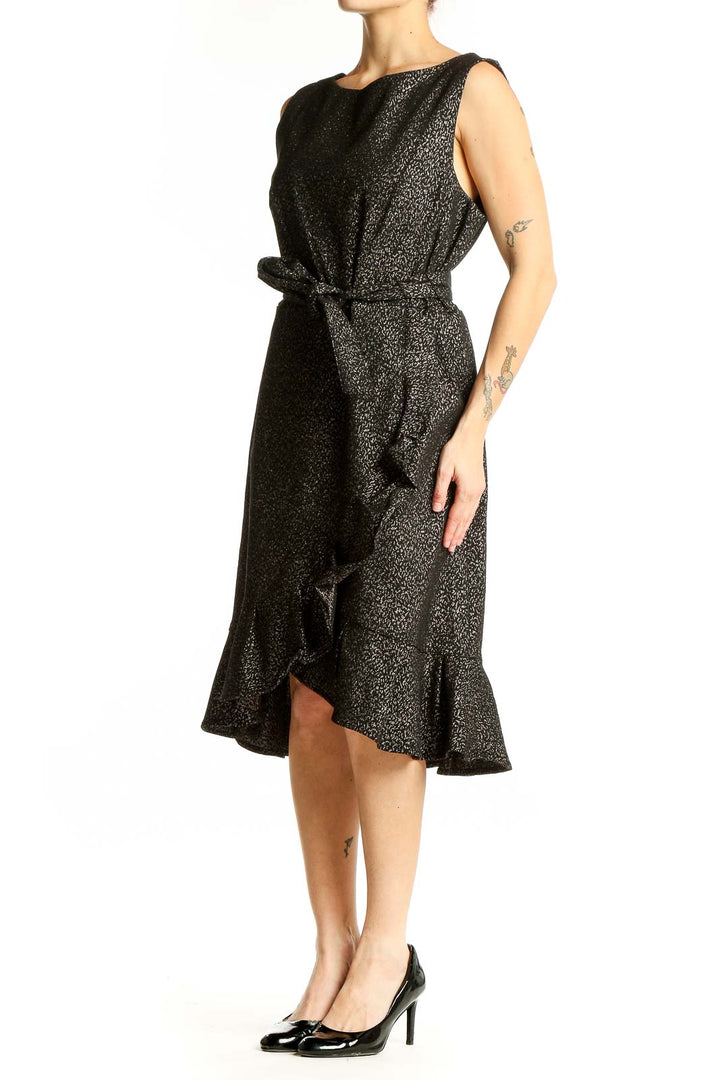 Front view of Calvin Klein black metallic ruffle wrap dress with tie waist