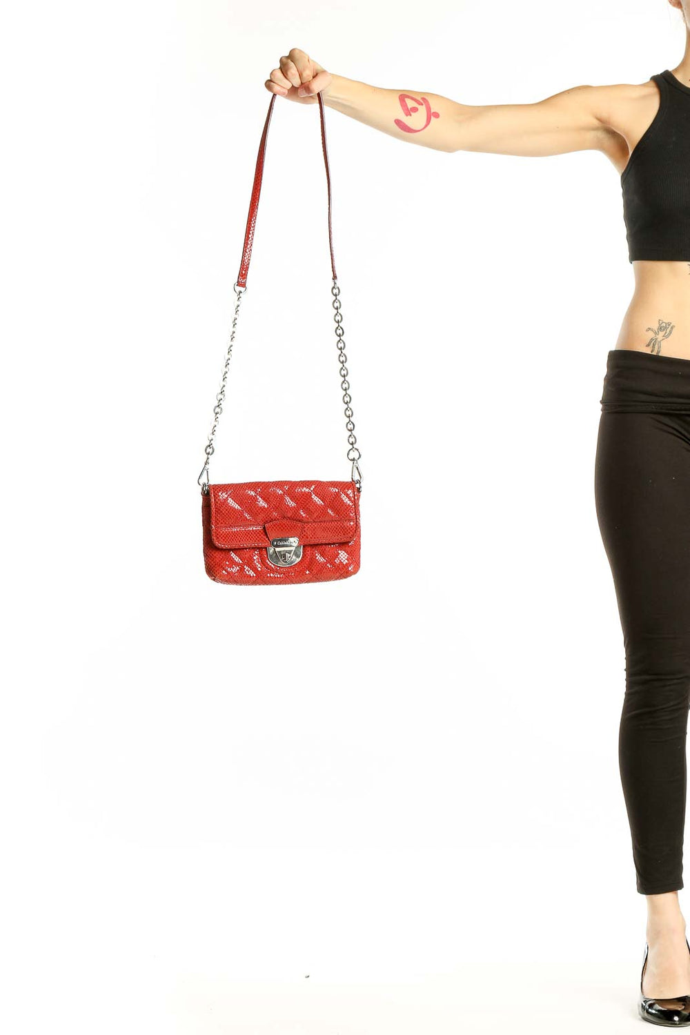 Front view of red quilted Calvin Klein crossbody bag with chain strap
