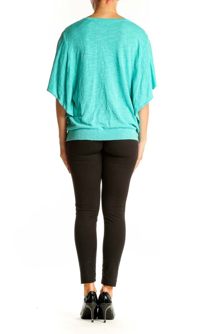 Side view of teal Jones New York button-front cardigan showing drape and fit