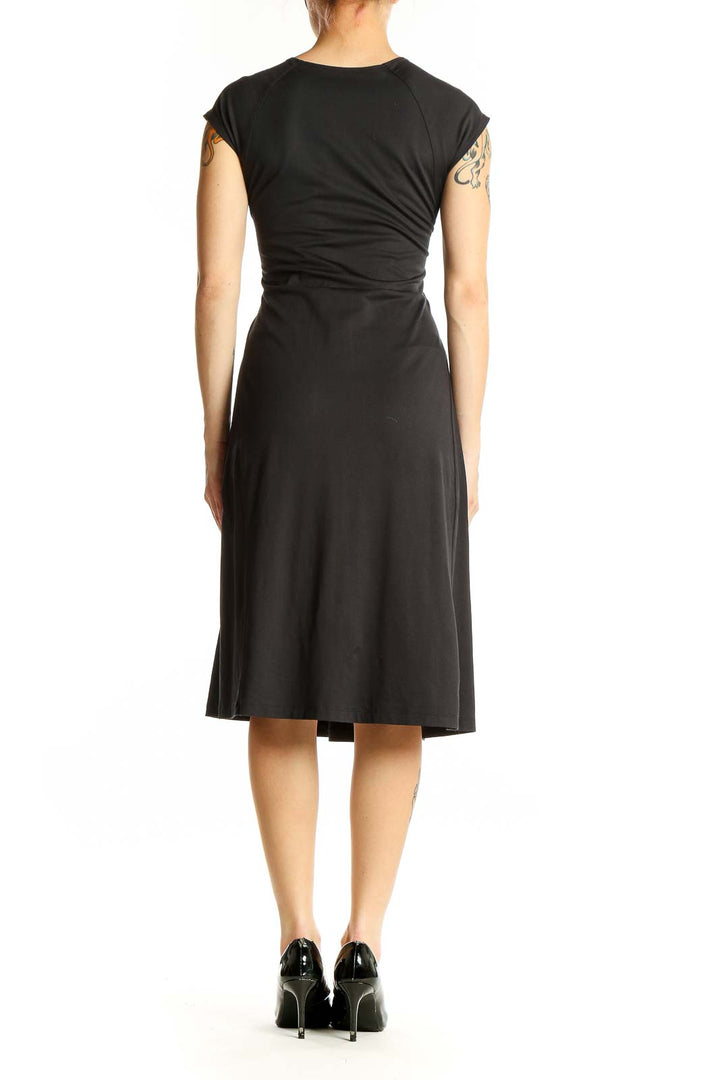 Side view of black Patagonia V-neck midi dress showing A-line silhouette