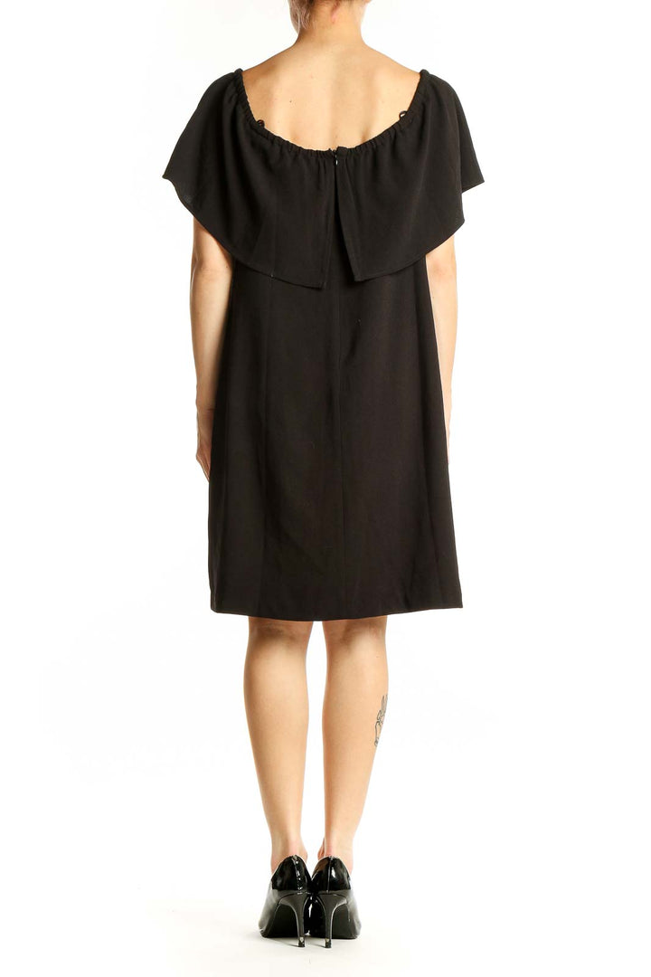 Side view of black off-shoulder cocktail dress by Charles Henry