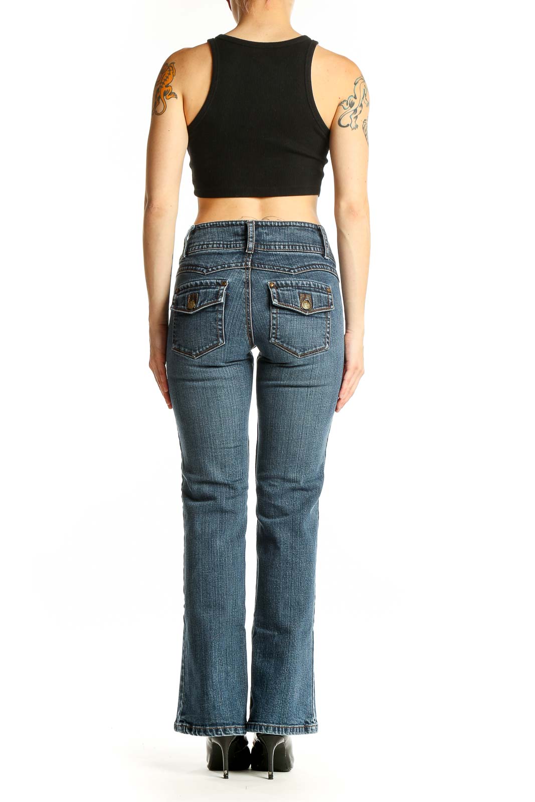 Side view of Cabi blue bootcut jeans on model with black crop top