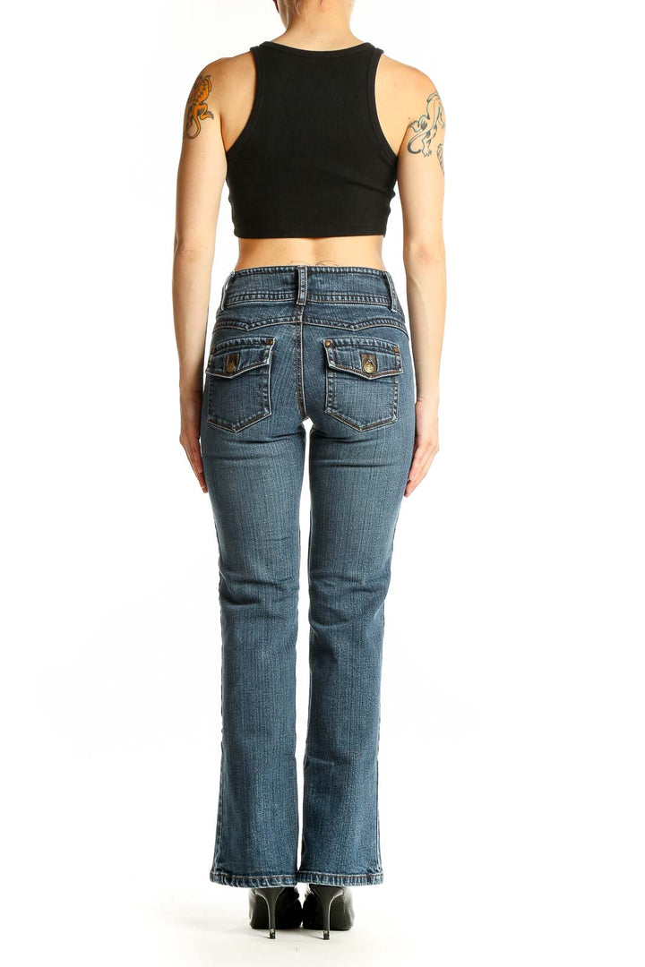 Side view of Cabi blue bootcut jeans on model with black crop top