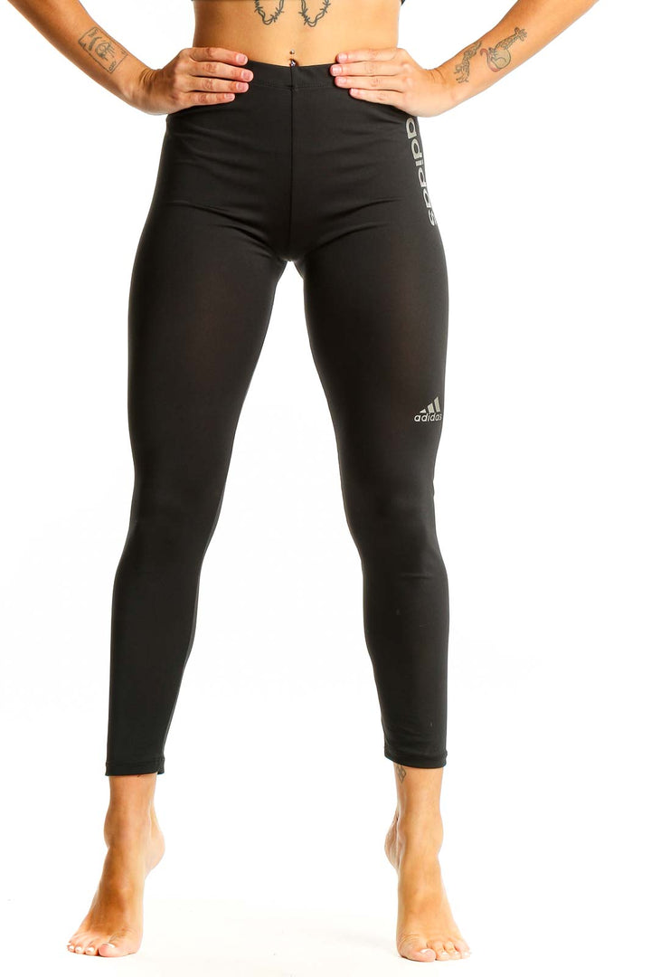 Front view of black Adidas high-waisted performance leggings