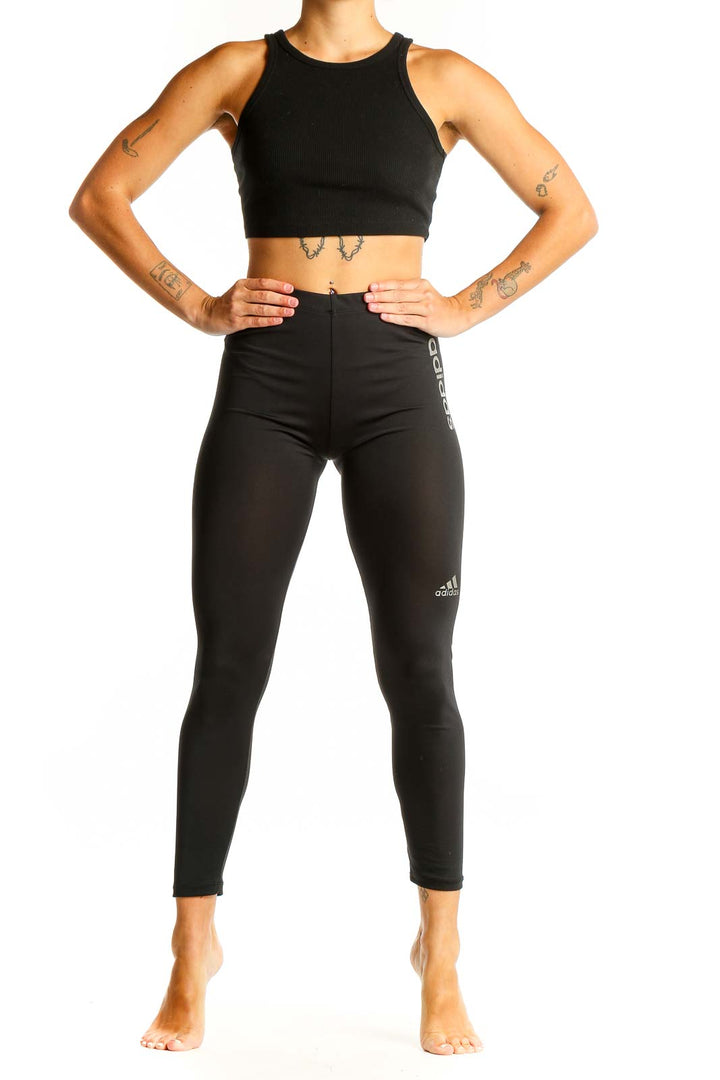 Front view of black Adidas high-waisted performance leggings