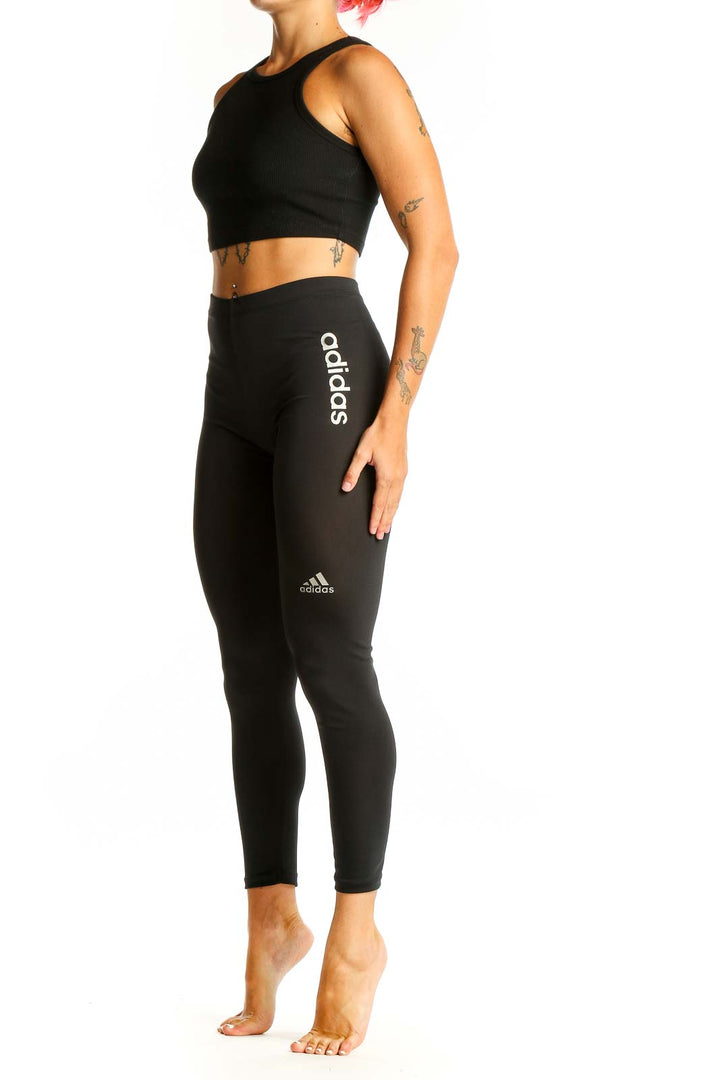 Front view of black Adidas high-waisted performance leggings