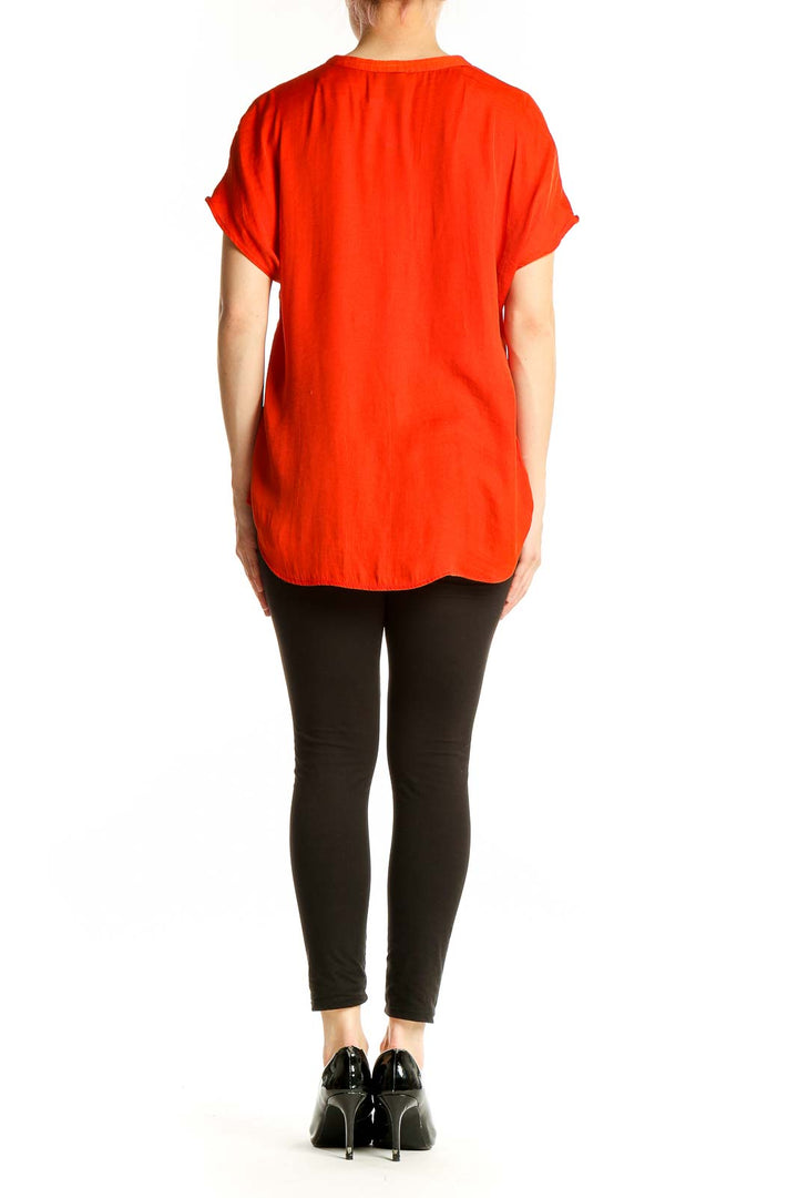Side view of red RACHEL Rachel Roy V-neck short sleeve blouse on model